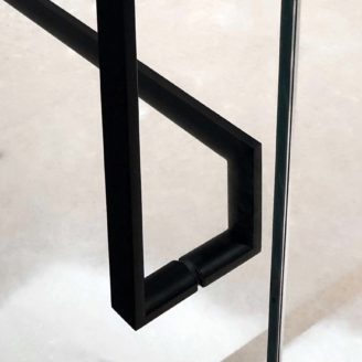 A close up view of a back to back handle installation between two matte black glass door handles.