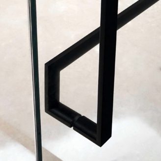 A close up view of a back to back handle installation between two matte black glass door handles.