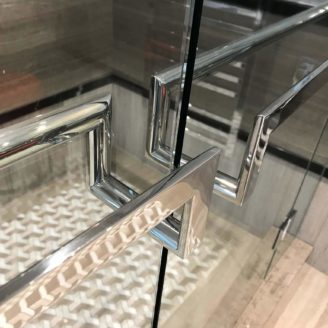 Back to back mounted glass door handles finished in polished stainless steel. Installed in a master ensuite shower.