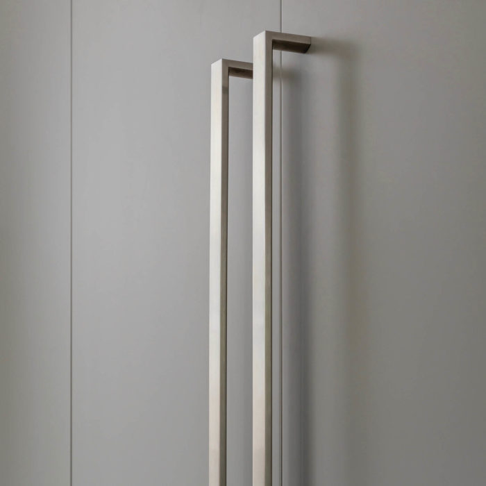 a closeup view of two stainless steel appliance door handles.