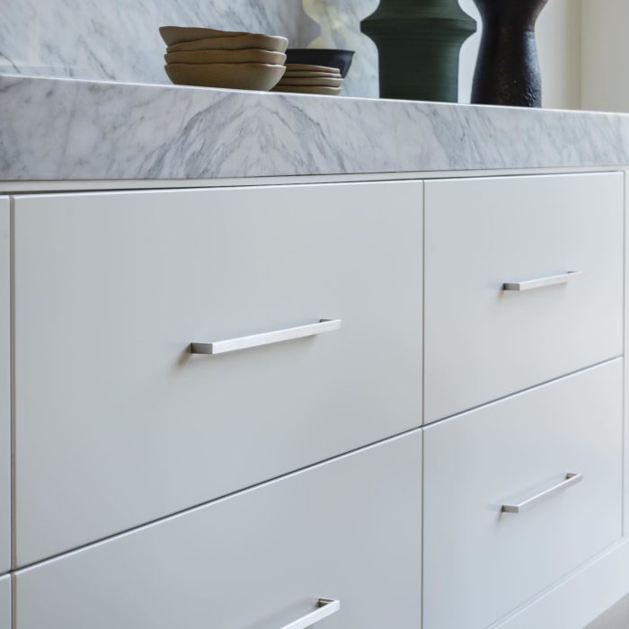 contemporary stainless steel d pulls on a modern cabinet with Carrara marble countertop