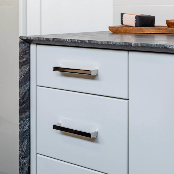 Bathroom vanity drawer pulls finished in polished stainless.