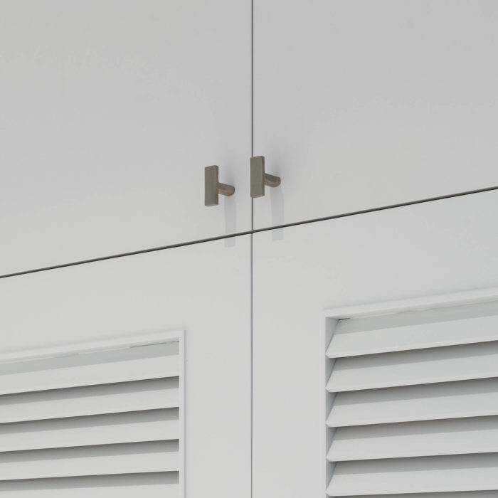 Satin stainless cabinet knobs mounted on a laundry room louvered doors