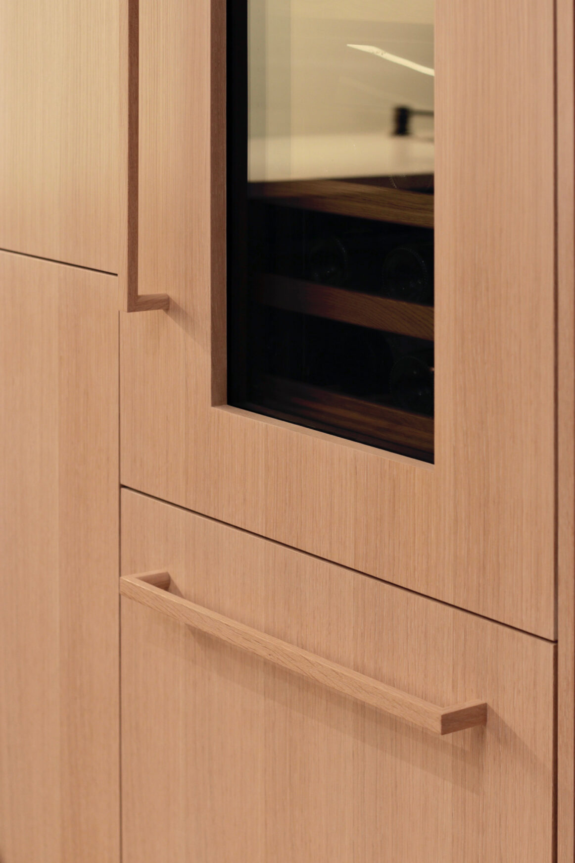 Oak appliance door handles Oak appliance door handles mounted on a wine fridge and freezer door.