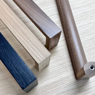Solid wood cabinet and door handles in oak, walnut and stained black oak.