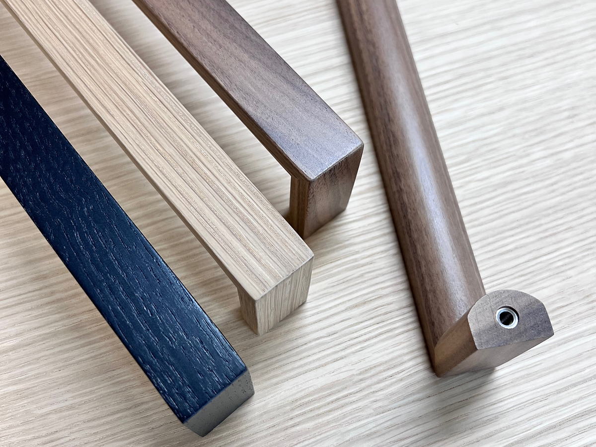 Solid wood cabinet and door handles in oak, walnut and stained black oak.